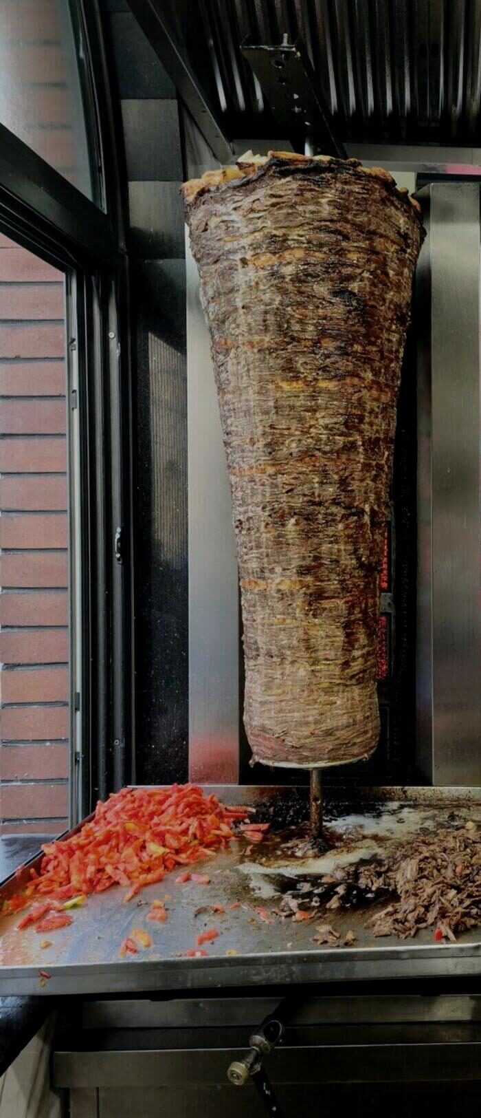 Beef and lamb döner roasting on the vertical spit